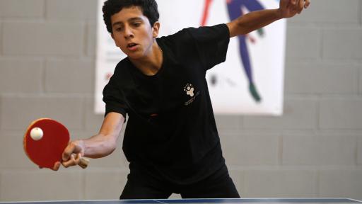 Aluno a jogar ténis de mesa