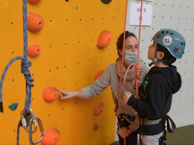 aluno a fazer escalada indoor